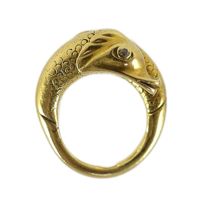 An early 20th century continental gold and diamond chip set twin dolphin crossover ring